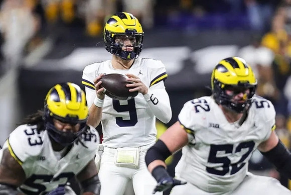 Trente Jones (53), J.J. McCarthy (9), and Karsen Barnhart (52)