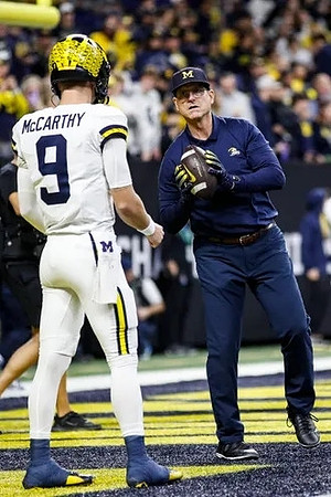 J.J. McCarthy (9) and Jim Harbaugh