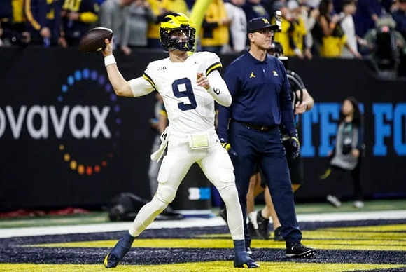 J.J. McCarthy (9) and Jim Harbaugh