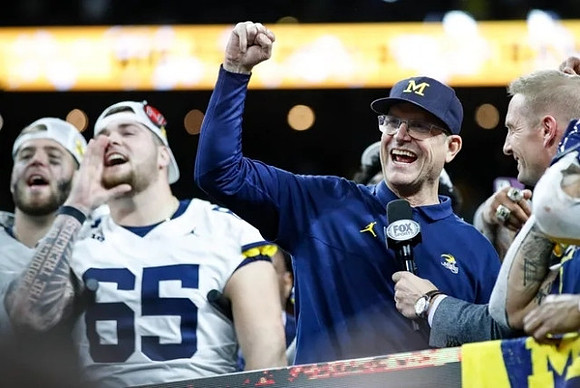 Zak Zinter (65) and Jim Harbaugh