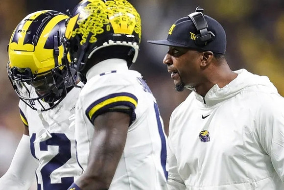 Josh Wallace (12) and Mike Sainristil (0)