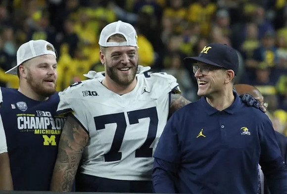 Drake Nugent (60), Trevor Keegan (77), and Jim Harbaugh