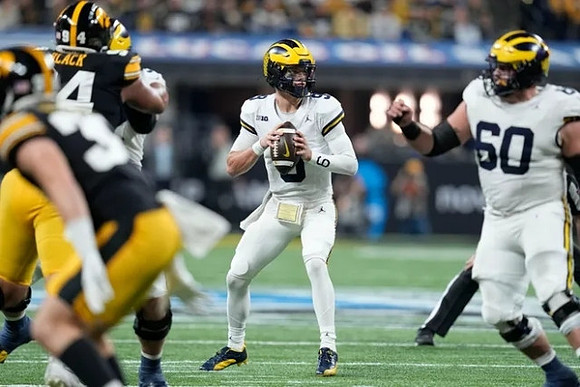 J.J. McCarthy (9) and Drake Nugent (60)
