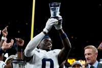 Mike Sainristil (0) and Big Ten Championship MVP Trophy