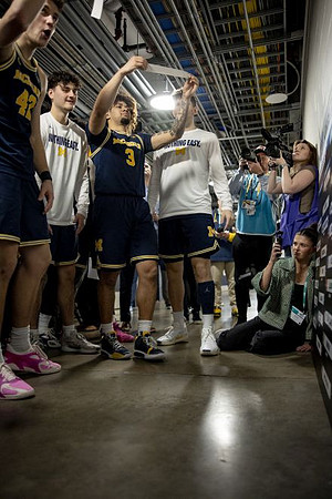 Will Tschetter (42), Tre Donaldson (3), and Michigan Team