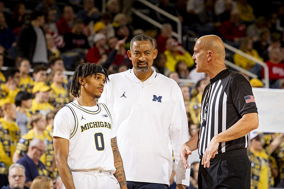 Dug McDaniel (0) and Juwan Howard