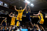 Olivier Nkamhoua (13), Tarris Reed Jr. (32), and Dug McDaniel (0)