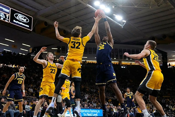 Olivier Nkamhoua (13), Tarris Reed Jr. (32), and Dug McDaniel (0)