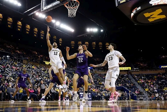 DeVante' Jones (12) and Brandon Johns Jr. (23)