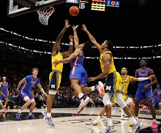 Tarris Reed Jr. (32), Nimari Burnett (4), and Olivier Nkamhoua (13)