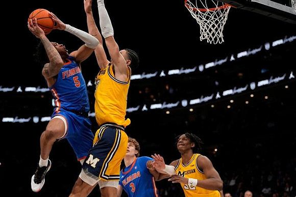 Olivier Nkamhoua (13) and Tarris Reed Jr. (32)