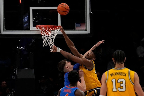 Tarris Reed Jr. (32) and Olivier Nkamhoua (13)