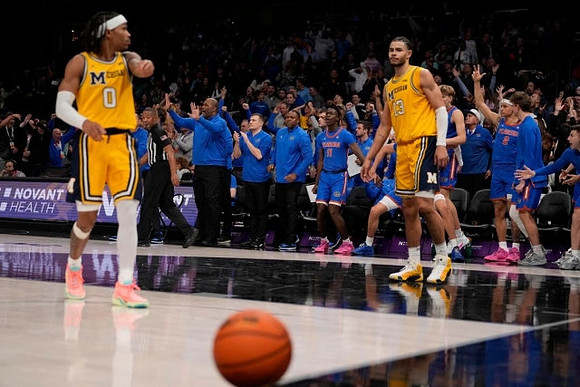Dug McDaniel (0) and Olivier Nkamhoua (13)