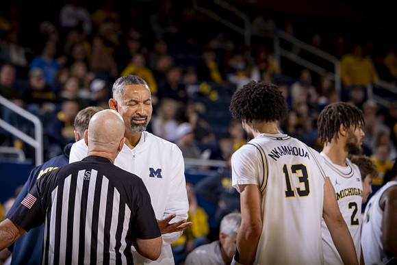 Juwan Howard, Olivier Nkamhoua (13), and Tray Jackson (2)