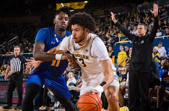 Olivier Nkamhoua (13) and McNeese State Head Coach Will Wade