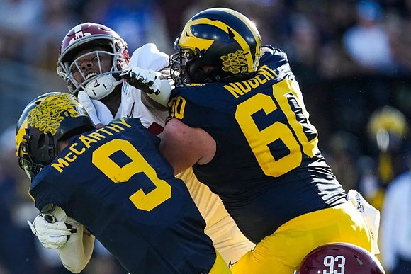 J.J. McCarthy (9) and Drake Nugent (60)