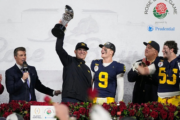 Jim Harbaugh, J.J. McCarthy (9), Warde Manuel, and Mason Graham (55)