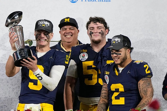 J.J. McCarthy (9), Warde Manuel, Mason Graham (55), and Blake Corum (2)