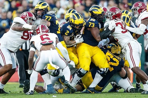 Trevor Keegan (77), Blake Corum (2), LaDarius Henderson (73), and Karsen Barnhart (52)