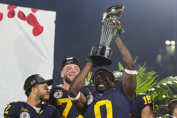 Blake Corum (2), Trevor Keegan (77), Mike Sainristil (0), Colston Loveland (18), and Rose Bowl Trophy