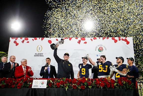 Jim Harbaugh, J.J. McCarthy (9), Mason Graham (55), Blake Corum (2), UofM President Santa Ono, and Rose Bowl Trophy
