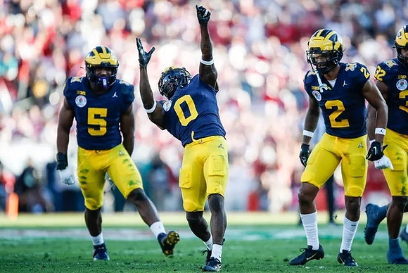 Josaiah Stewart (5), Mike Sainristil (0), Will Johnson (2), and Jaylen Harrell (32)