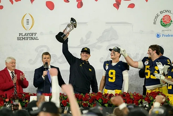 Jim Harbaugh, J.J. McCarthy (9), Mason Graham (55), Blake Corum (2), and Rose Bowl Trophy