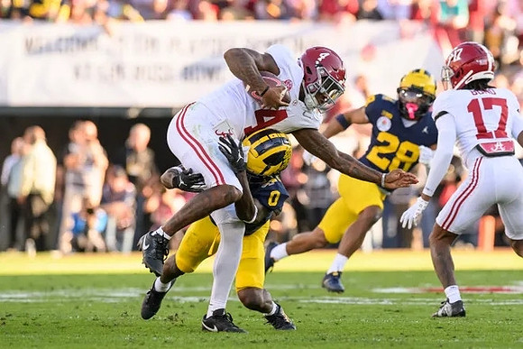 Mike Sainristil (0) and Quinten Johnson (28)