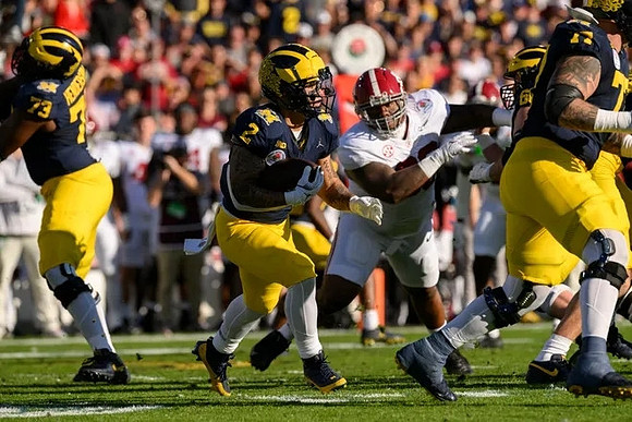 LaDarius Henderson (73), Blake Corum (2), and Trevor Keegan (77)