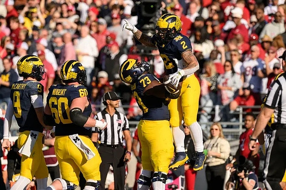 J.J. McCarthy (9), Drake Nugent (60), LaDarius Henderson (73), and Blake Corum (2)