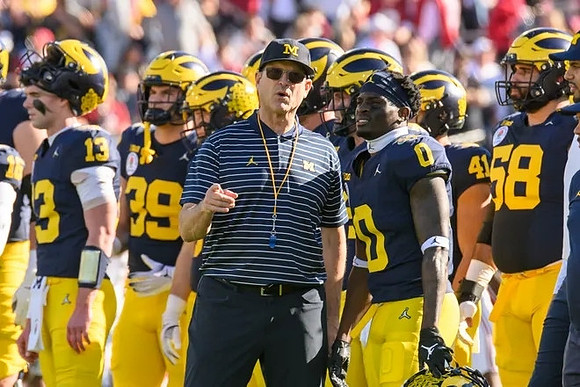 Jim Harbaugh, Mike Sainristil (0), and Michigan Team
