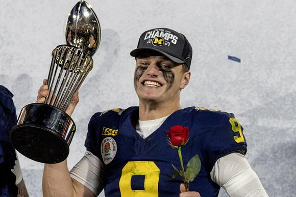 J.J. McCarthy (9) and Rose Bowl Trophy