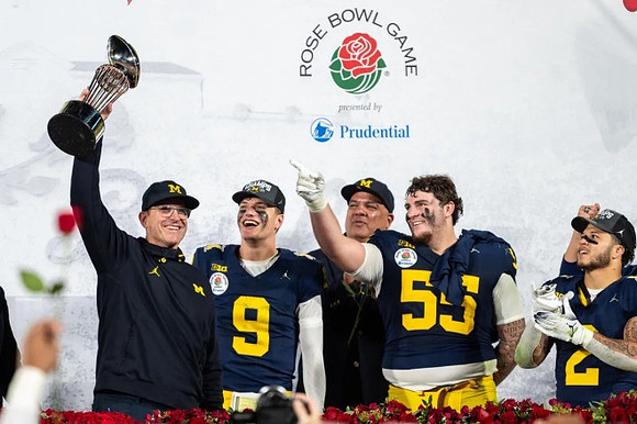 Jim Harbaugh, J.J. McCarthy (9), Warde Manuel, Mason Graham (55), Blake Corum (2), and Rose Bowl Trophy