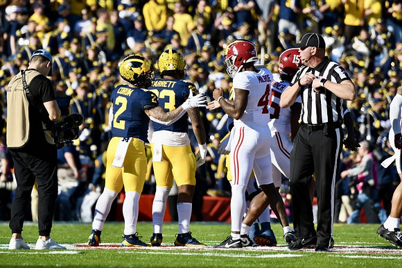 Blake Corum (2) and Michael Barrett (23)