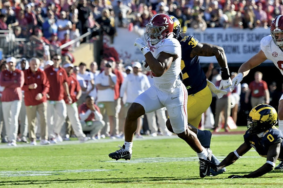 Jaylen Harrell (32) and Mike Sainristil (0)