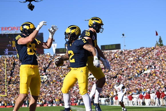 AJ Barner (89), Blake Corum (2), and Colston Loveland (18)
