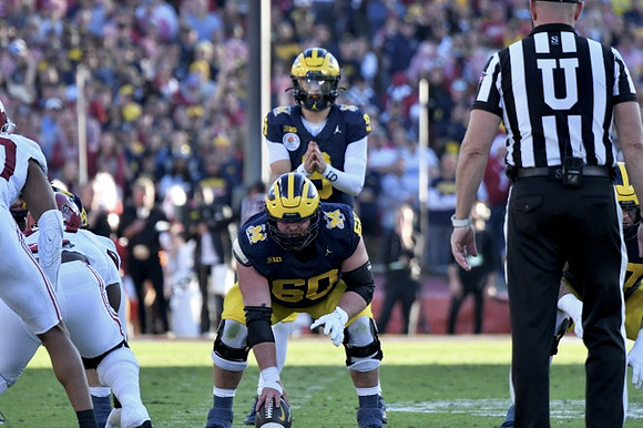 Drake Nugent (60) and J.J. McCarthy (9)