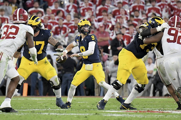 Trevor Keegan (77), J.J. McCarthy (9), and LaDarius Henderson (73)