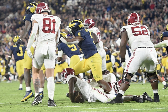 Mike Sainristil (0), Josaiah Stewart (5), and Rod Moore (9)