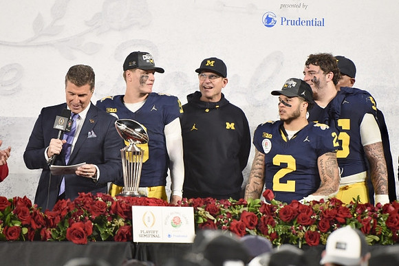 J.J. McCarthy (9), Jim Harbaugh, Blake Corum (2), Mason Graham (55), Warde Manuel, and Rose Bowl Trophy