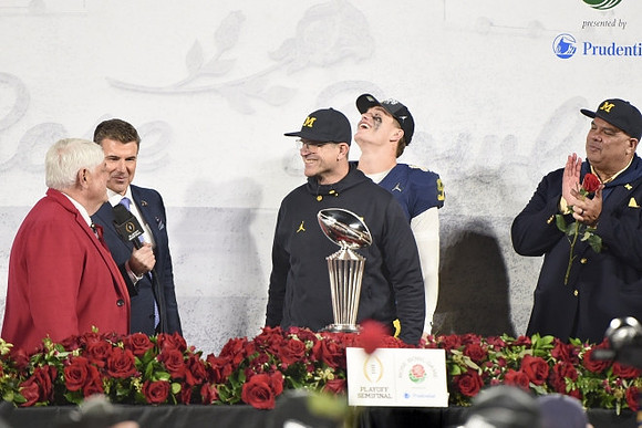 Jim Harbaugh, J.J. McCarthy (9), Warde Manuel, and Rose Bowl Trophy