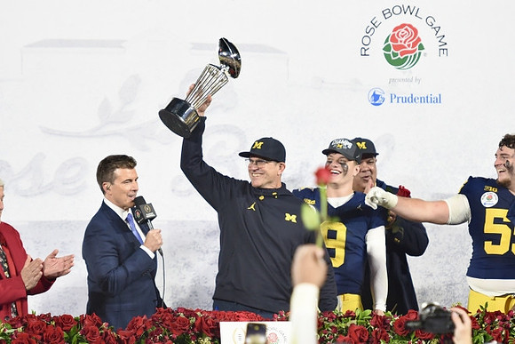 Jim Harbaugh, J.J. McCarthy (9), Warde Manuel, Mason Graham (55), and Rose Bowl Trophy