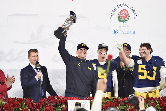 Jim Harbaugh, J.J. McCarthy (9), Warde Manuel, Mason Graham (55), and Rose Bowl Trophy