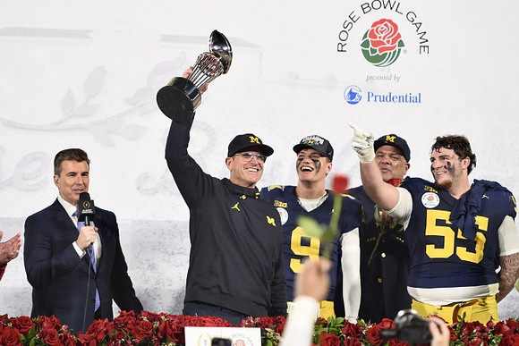 Jim Harbaugh, J.J. McCarthy (9), Warde Manuel, Mason Graham (55), and Rose Bowl Trophy