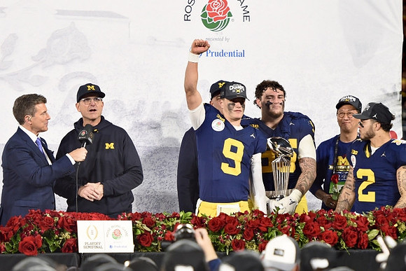 Jim Harbaugh, J.J. McCarthy (9), Warde Manuel, Mason Graham (55), UofM President Santa Ono, Blake Corum (2), and Rose Bowl Trophy