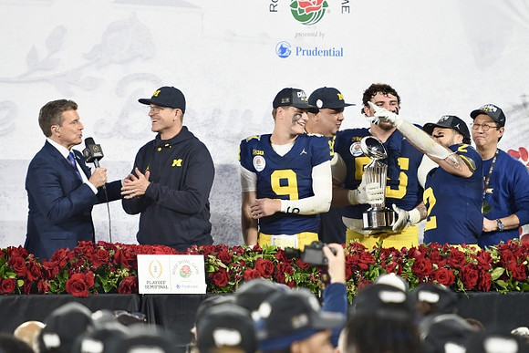 Jim Harbaugh, J.J. McCarthy (9), Warde Manuel, Mason Graham (55), UofM President Santa Ono, Blake Corum (2), and Rose Bowl Trophy