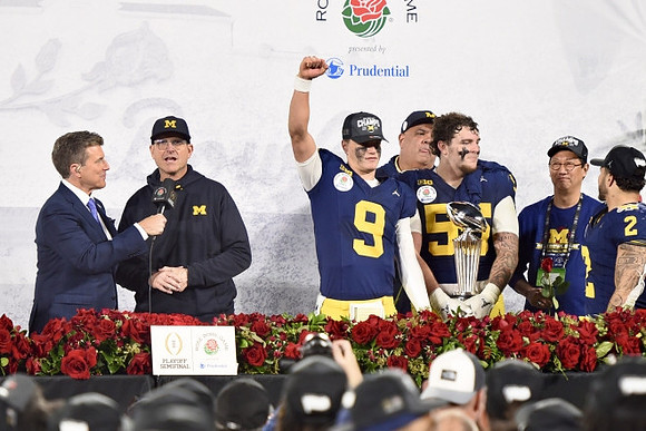 Jim Harbaugh, J.J. McCarthy (9), Warde Manuel, Mason Graham (55), UofM President Santa Ono, Blake Corum (2), and Rose Bowl Trophy