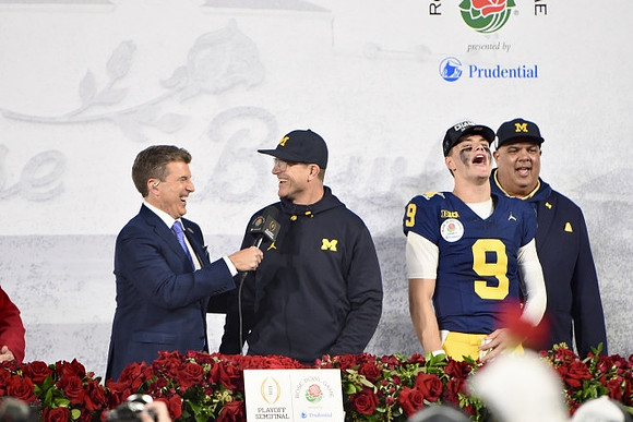 Jim Harbaugh, J.J. McCarthy (9), and Warde Manuel