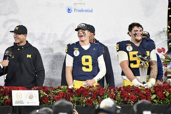 Jim Harbaugh, J.J. McCarthy (9), and Mason Graham (55)