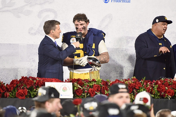 Mason Graham (55), Warde Manuel, and Rose Bowl Trophy